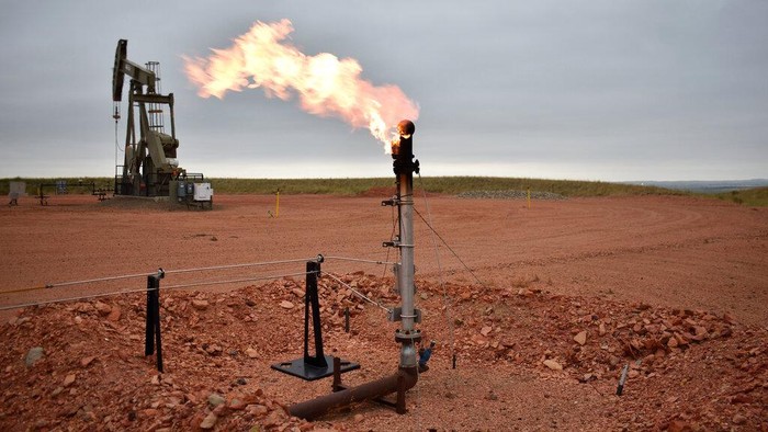 A flare burns excess methane, or natural gas, from crude oil production at a well pad in Watford City, N.D., Aug. 26, 2021. Global carbon pollution this year has bounced back to almost 2019 levels, after a drop thanks to the pandemic lockdown. (AP Photo/Matthew Brown)