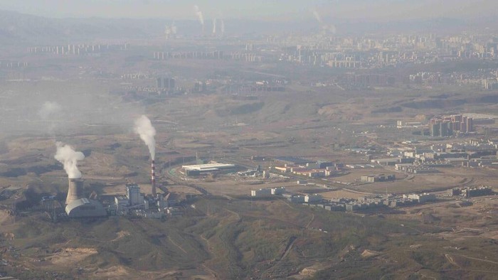 FILE - In this Wednesday, April 21, 2021 file photo, smoke and steam rise from towers at the coal-fired Urumqi Thermal Power Plant in Urumqi in western China's Xinjiang Uyghur Autonomous Region. China is offering no significant new goals for reducing climate-changing emissions ahead of the UN climate summit set to start Sunday, Oct. 31, 2021 in Glasgow, Scotland. (AP Photo/Mark Schiefelbein)