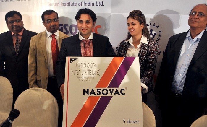 Serum Institute of India's Executive Director Adar Poonawalla and his wife Natasha launch the country's first nasal H1N1 vaccine, 'Nasovac', at a news conference in Mumbai on July 14, 2010. India's largest vaccine manufacturer, Serum Institute, announced the launch of its indigenously developed intra-nasal vaccine named Nasovac for preventing H1N1 infections. The single dose vaccine, fitted at the top of a syringe, is just to be sniffed once in each nostril making it a painless procedure. AFP PHOTO/ Punit PARANJPE (Photo by PUNIT PARANJPE / AFP)