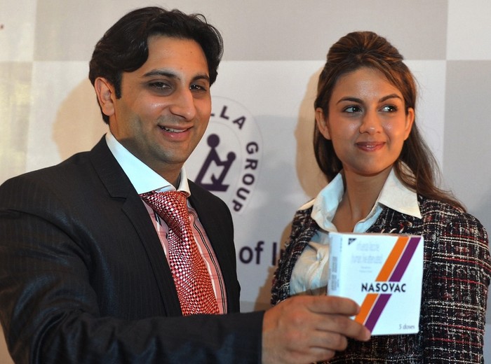 Adar Poonawalla Serum Institute of India's Executive Director Adar Poonawalla and his wife Natasha launch the country's first nasal H1N1 vaccine, 'Nasovac', at a news conference in Mumbai on July 14, 2010. India's largest vaccine manufacturer, Serum Institute, announced the launch of its indigenously developed intra-nasal vaccine named Nasovac for preventing H1N1 infections. The single dose vaccine, fitted at the top of a syringe, is just to be sniffed once in each nostril making it a painless procedure. AFP PHOTO/ Punit PARANJPE (Photo by PUNIT PARANJPE / AFP)