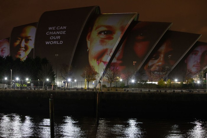 GLASGOW, SCOTLAND - NOVEMBER 05: Faces and messages appear during the projection of #ProjectingChange onto the exterior of SEC Armadillo on November 5, 2021 in Glasgow, Scotland. #ProjectingChange is an art activation created by world-renowned artists intended to inspire hope around the climate crisis during the 26th United Nations Climate Conference. (Photo by Jeremy Sutton-Hibbert/Getty Images for #ProjectingChange)