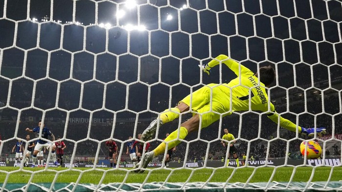 AC Milans goalkeeper Ciprian Tatarusanu saves a penalty by Inter Milans Lautaro Martinez during the Serie A soccer match between AC Milan and Inter Milan at the San Siro stadium, in Milan, Italy, Sunday, Nov. 7, 2021. (AP Photo/Antonio Calanni)