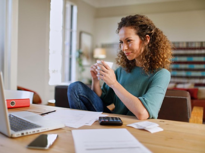 Single, woman at home with technology. She is wearing high tech sports wear. Brazilian model made in Barcelona.