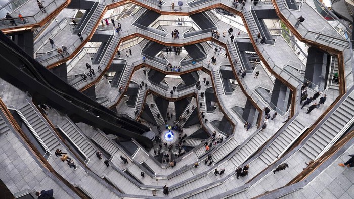 AS FILE - In this March 15, 2019, file photo, visitors to the Vessel climb its staircases on its opening day at Hudson Yards, in New York. Officials are evaluating the future of the 150-foot-tall piece of public art in New York City after a string of suicides. (AP Photo/Mark Lennihan, File)