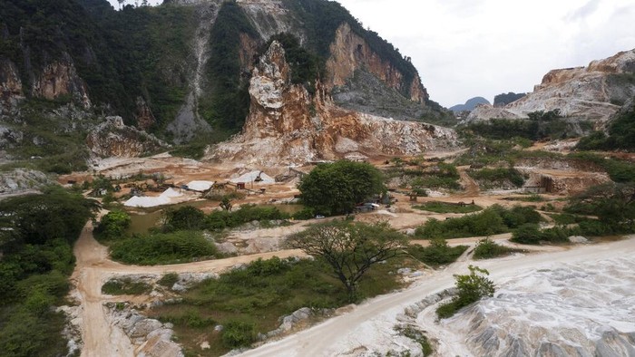 Deforestation surrounds massive limestone quarries cut into the mountains of Ipoh, Perak state Malaysia, Friday, Nov. 5, 2021. Deforestation affects the people and animals where trees are cut, as well as the wider world and in terms of climate change, and cutting trees both adds carbon dioxide to the air and removes the ability to absorb existing carbon dioxide. World leaders are gathered in Scotland at a United Nations climate summit, known as COP26, to push nations to ratchet up their efforts to curb climate change. (AP Photo/Vincent Thian)