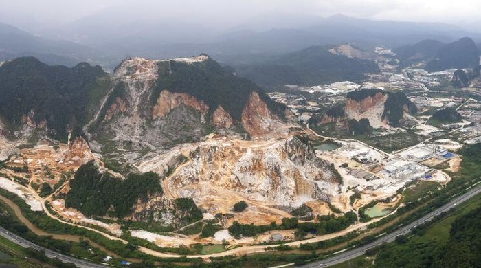 Deforestation surrounds massive limestone quarries cut into the mountains of Ipoh, Perak state Malaysia, Friday, Nov. 5, 2021. Deforestation affects the people and animals where trees are cut, as well as the wider world and in terms of climate change, and cutting trees both adds carbon dioxide to the air and removes the ability to absorb existing carbon dioxide. World leaders are gathered in Scotland at a United Nations climate summit, known as COP26, to push nations to ratchet up their efforts to curb climate change. (AP Photo/Vincent Thian)