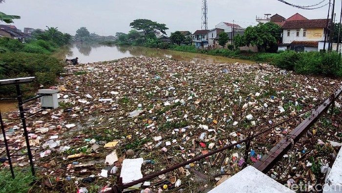Debit air Sungai Cikeruh meningkat, membuat sampah menumpuk di jembatan sungai yang berada di Kecamatan Bojongsoang, Kabupaten Bandung, Rabu (10/11/2021) pagi.