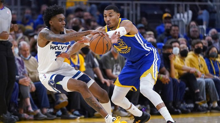 Minnesota Timberwolves forward Jaden McDaniels, left, is defended by Golden State Warriors forward Otto Porter Jr. during the second half of an NBA basketball game in San Francisco, Wednesday, Nov. 10, 2021. (AP Photo/Jeff Chiu)