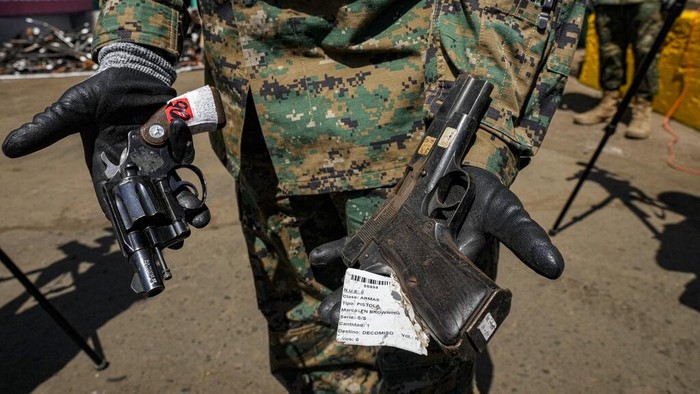13.000 Senjata Api di Chile Dimusnahkan A Chilean Army officer shows weapons that were voluntarily turned over to police or seized, before melting them at a foundry in Santiago, Chile, Thursday, Nov. 11, 2021. More than 13,600 illegal weapons were destroyed, according to a national commission that regulates weapons. (AP Photo/Esteban Felix)