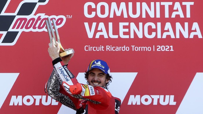 MotoGP rider Francesco Bagnaia of Italy celebrates on the podium after winning the Valencia Motorcycle Grand Prix, the last race of the season, at the Ricardo Tormo circuit in Cheste, near Valencia, Spain, Sunday, Nov. 14, 2021. (AP Photo/Alberto Saiz)