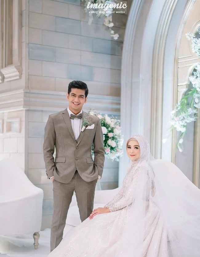 Untuk resepsi Ricis tampil dengan 2 look. Selain gaun berwarna biru, Ricis juga terlihat mengenakan ballgown putih berhias payet. Sedangkan untuk look kedua, Teuku Ryan memilih setelan jas berwarna abu-abu kecoklatan. Penampilannya itu dilengkapi dengan dasi kupu-kupu. (Foto: Instagram/@riaricis1795/@imagenic)