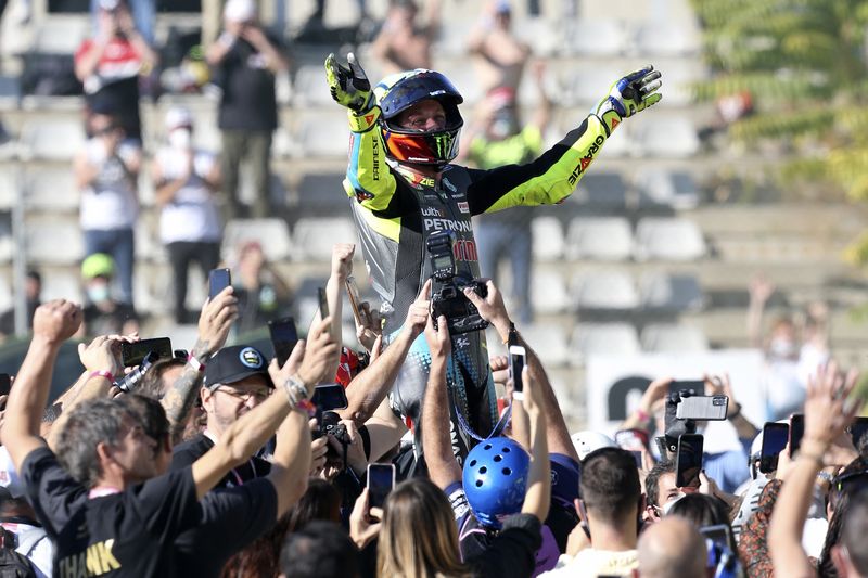 MotoGP rider Valentino Rossi of Italy waves at the end of the Valencia Motorcycle Grand Prix, the last race of the season, at the Ricardo Tormo circuit in Cheste, near Valencia, Spain, Sunday, Nov. 14, 2021. Rossi will be retiring from MotoGP racing as the season ends in Valencia. (AP Photo/Alberto Saiz)
