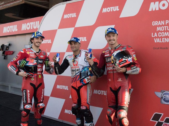 VALENCIA, SPAIN - NOVEMBER 13: (L-R) Francesco Bagnaia of Italy and Ducati Lenovo Team, Jorge Martin of Spain and Pramac Racing team and Jack Miller of Australia and Ducati Lenovo Team pose at the end of the MotoGP qualifying practice during the MotoGP of Comunitat Valenciana: Qualifying at Ricardo Tormo Circuit on November 13, 2021 in Valencia, Spain. (Photo by Mirco Lazzari gp/Getty Images)