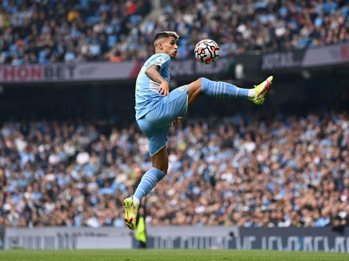 MANCHESTER, ENGLAND - AUGUST 21:  Joao Cancelo of Manchester City controls the ball during the Premier League match between Manchester City  and  Norwich City at Etihad Stadium on August 21, 2021 in Manchester, England. (Photo by Shaun Botterill/Getty Images )