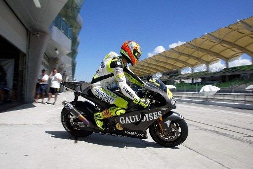 Valentino Rossi of Italy rides his Yamaha out of the pits during testing at the Sepang Circuit in Malaysia, 11 February 2004. Several MotoGP teams are conducting testing sessions at Sepang prior to the start of the 2004 season.  AFP PHOTO / Jimin LAI (Photo by JIMIN LAI / AFP)