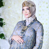 Adhitya Putri memakai busana dengan model kerah Kartini transparan berhias aksen sulur warna emas, yang dipadu inner hijab warna putih. Sementara untuk bawahan, aktris jebolan Gadis Sampul ini mengenakan kain batik. Foto: Instagram