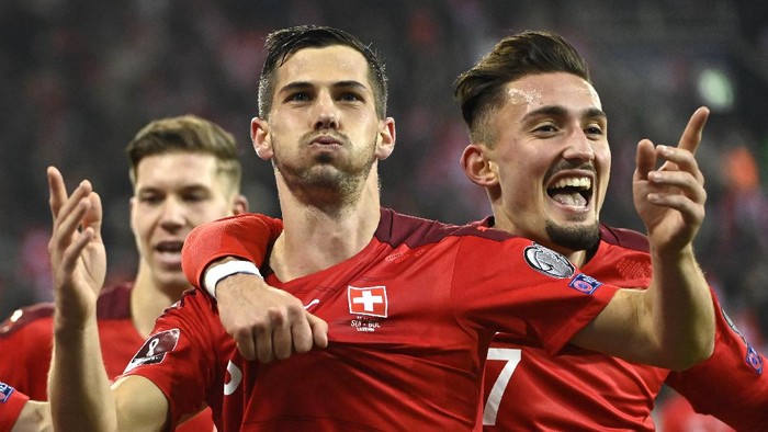Switzerlands Remo Freuler, center, celebrates scoring with Andi Zeqiri, right, during the World Cup 2022 qualifying soccer match between Switzerland and Bulgaria at the Swissporarena stadium in Lucerne, Switzerland, Monday, Nov. 15, 2021. (Alessandro della Valle/Keystone via AP)