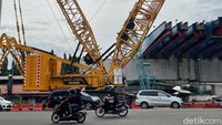Crawler crane Sany SCC8000A menyelesaikan pemasangan girder di Tol Becakayu yang melintas di atas ruas jalan Achmad Yani, Kota Bekasi, Rabu (17/11/2021).