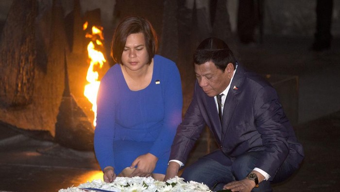 FILE - Philippine President Rodrigo Duterte and his daughter Sara lay a wreath during a memorial ceremony at the Yad Vashem Holocaust Memorial in Jerusalem on Sept 3, 2018. Philippine President Rodrigo Dutertes daughter registered her candidacy Saturday, Nov. 13, 2021 for vice president in next years elections and was adopted as the running mate of presidential candidate Ferdinand Marcos Jr., the son of the late Filipino dictator, in an alliance that immediately set off alarms among human rights activists. (AP Photo/Oded Balilty, File)