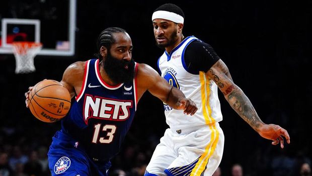 Brooklyn Nets' James Harden (13) drives past Golden State Warriors' Gary Payton II (0) during the second half of an NBA basketball game Tuesday, Nov. 16, 2021 in New York. The Warriors won 117-99. (AP Photo/Frank Franklin II)
