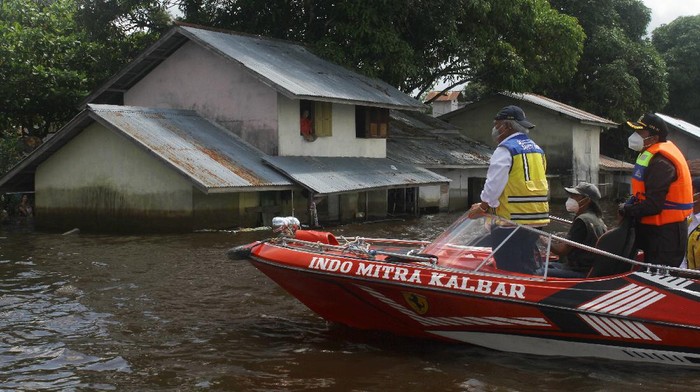 Naik Speed Boat, Menteri PUPR Tinjau Kondisi Banjir di Sintang Menteri Pekerjaan Umum dan Perumahan Rakyat (PUPR) Basuki Hadimuljono (kanan) memberikan bantuan sembako untuk korban banjir di tepian Sungai Kapuas di Sintang, Kalimantan Barat, Kamis (18/11/2021). Menteri PUPR menyatakan pihaknya siap melakukan rekayasa untuk penanganan banjir di Kabupaten Sintang, terutama menghadapi prediksi banjir besar yang akan terjadi pada Januari 2022. ANTARA FOTO/Jessica Helena Wuysang/nz