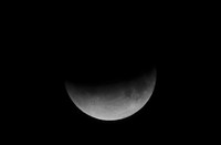 I this Tuesday, July 16, 2019 photo, men stand below street lights as the moon rises during a partial lunar eclipse in Buenos Aires, Argentina. (AP Photo/Natacha Pisarenko)