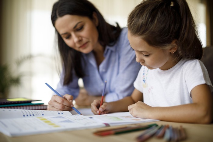 Mother helping daughter with homework