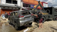 Tak sedikit mobil rusak terdampak banjir di kawasan Sintang. Tampak sejumlah petugas Perumdam Tirta Senentang dan Paldam XII/Tanjungpura berupaya mengevakuasi mobil dari dalam parit di Jalan Lintas Melawi, Kabupaten Sintang, Kalimantan Barat, pada Jumat (19/11) lalu. ANTARA FOTO/Jane Elisabeth Wuysang.