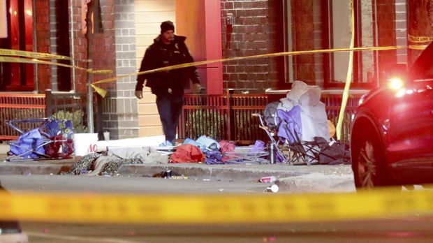 Police investigate at the scene of a crash involving multiple people and injuries at a holiday parade in Waukesha, Wis., on Sunday, Nov. 21, 2021. (Mike De Sisti/Milwaukee Journal-Sentinel via AP)
