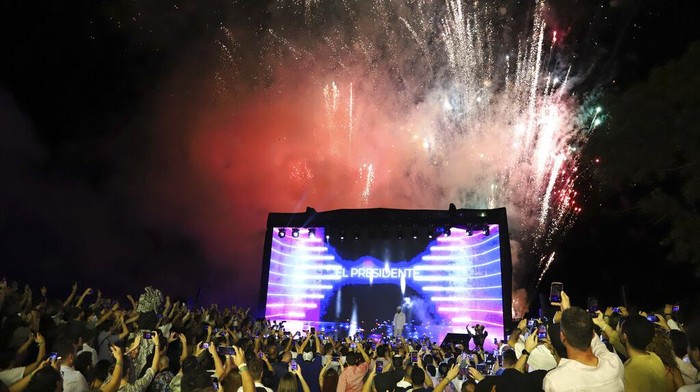 El Salvador's President Nayib Bukele participates in the closing ceremony of a congress for cryptocurrency investors in Santa Maria Mizata, El Salvador, Saturday, Nov. 20, 2021. Bukele announced during the rock concert-like atmosphere at the gathering that his government will build an oceanside 
