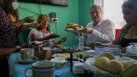 Capres Antonio Kast tak segan-segan mengambilkan makanan untuk disajikan ke warga yang menjamunya. Antonio Kast berasal dari Partai Republik dan cukup populer di kalangan bawah.