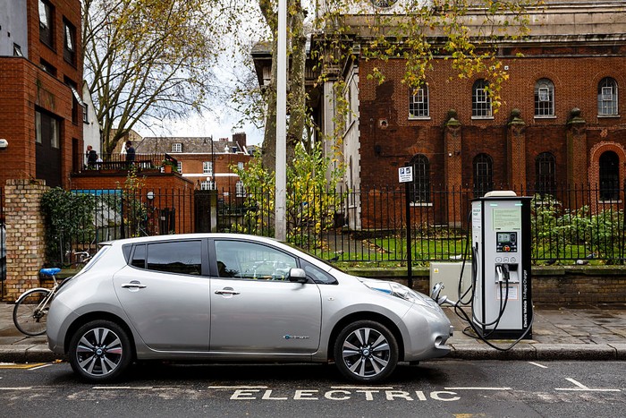 Go Ultra Low Nissan LEAF on charge on a London street. Ultra-low emission vehicles such as this can cost as little as 2p per mile to run and some electric cars and vans have a range of up to 700 miles.