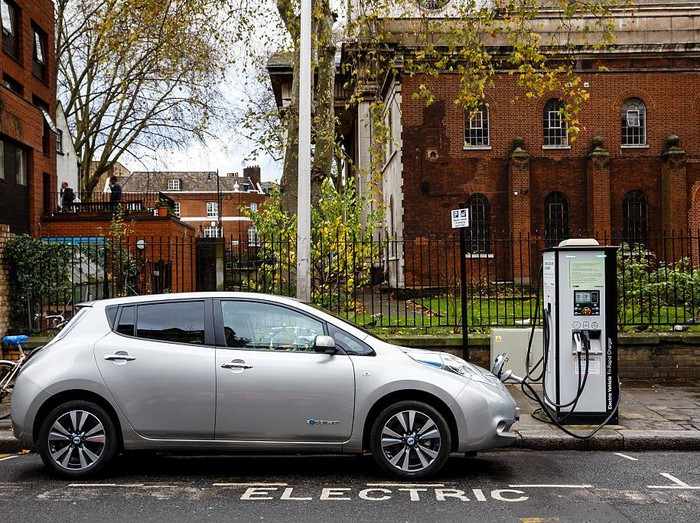 Go Ultra Low Nissan LEAF on charge on a London street. Ultra-low emission vehicles such as this can cost as little as 2p per mile to run and some electric cars and vans have a range of up to 700 miles.