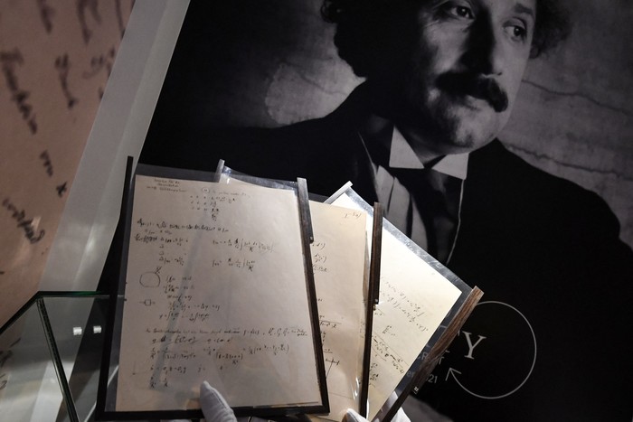 A picture taken on November 22, 2021 shows pages of one of the preparatory manuscript to the theory of general relativity of Albert Einstein, during their presention a day before being auctionned at Christies auction house in Paris. (Photo by Alain JOCARD / AFP)