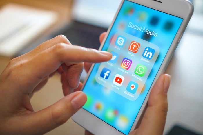 Bangkok, Thailand - JUN 18, 2018: social medial app iPhone mobile phone with blue screen background technology business smartphone digital communication facebook and internet editorial