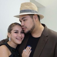 Dalam foto ini Ayu dan Ivan Gunawan tampak kompak dengan busana senada. Ayu tampak cantik dengan gaun berwarna hitam, sedangan Ivan mengenakan jas berwarna coklat gelap dengan dalaman berwarna hitam. Foto: Instagram/@ayutingting92