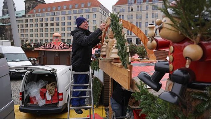 DRESDEN, GERMANY - NOVEMBER 23: Christmas market stand operators Marko Jeschky and his wife Anne dismantle their stand at the shuttered Striezelmarkt Christmas market during the fourth wave of the coronavirus pandemic on November 23, 2021 in Dresden, Germany. The state of Saxony, which is facing Covid infection rates that in many of its regions have topped 1,000 per 100,000 people over the last seven days, has imposed temporary lockdown restrictions, including closing all of the states's annual Christmas markets, in an effort to rein in infections. Germany as a whole is struggling to bring down infection rates that have topped one record after the next over recent weeks.  (Photo by Sean Gallup/Getty Images)