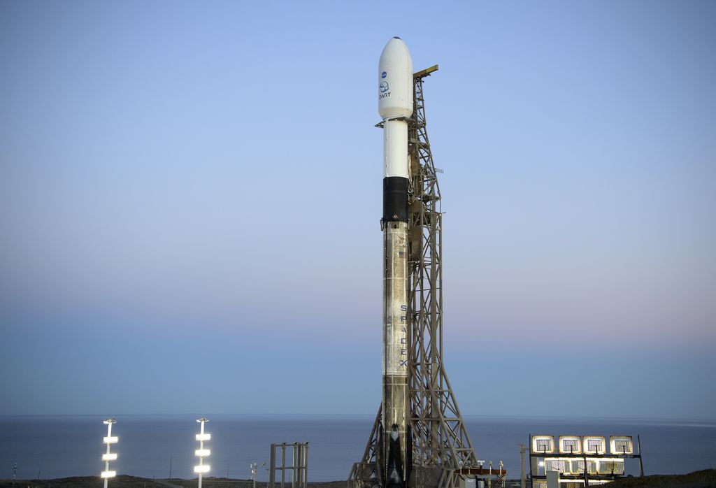 In this image provided by NASA, a SpaceX Falcon 9 rocket with the Double Asteroid Redirection Test, or DART, spacecraft onboard, sits during sunrise, Tuesday, Nov. 23, 2021, at Space Launch Complex 4E, Vandenberg Space Force Base, Calif. The A spacecraft is scheduled to launch Tuesday night on a collision course with an asteroid in the first test of whether Earth can be protected from a potentially disastrous impact by slightly altering the trajectory of a space rock.  (Bill Ingalls/NASA via AP)