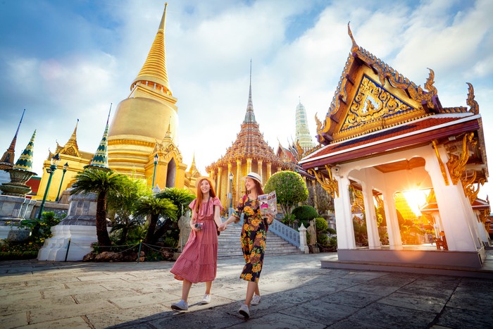 Asian girl walk in Wat phra kaew and grand palace travel in Bangkok city, Thailand