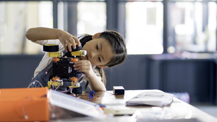 Young girl working on a robot design. Okayama, Japan