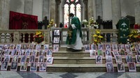 Foto-foto perempuan yang meninggal dengan cara kekerasan ditampilkan di altar ketika seorang imam merayakan Misa memperingati Hari Internasional untuk Penghapusan Kekerasan Terhadap Perempuan, di Katedral di La Paz, Bolivia, Kamis (25/11/2021). AP/Juan Karita  