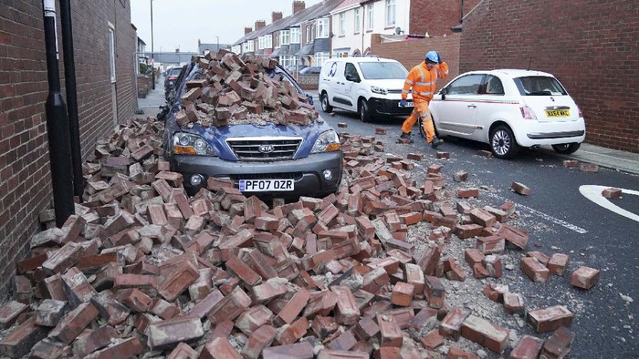 A truck lies on its side after being blown over by gusts of wind of almost 100 miles (160 km) per hour which battered some areas of the country during Storm Arwen, in Hartlepool, England, early Saturday Nov. 27, 2021. The Met Office issued a rare red warning for wind from 3pm on Friday to 2am on Saturday as the first winter storm was set to batter the country. (Owen Humphreys/PA via AP)