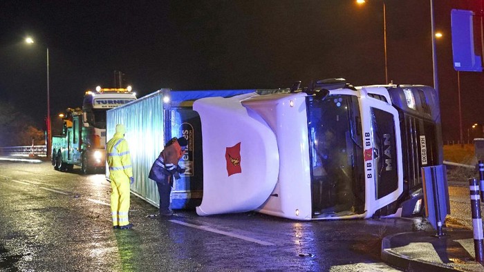 A truck lies on its side after being blown over by gusts of wind of almost 100 miles (160 km) per hour which battered some areas of the country during Storm Arwen, in Hartlepool, England, early Saturday Nov. 27, 2021. The Met Office issued a rare red warning for wind from 3pm on Friday to 2am on Saturday as the first winter storm was set to batter the country. (Owen Humphreys/PA via AP)