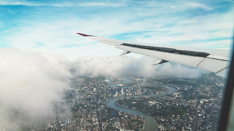 Ilustrasi penerbangan Aerial view of London from an airplane. Flying over London on a cloudy day.