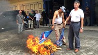 Foto: Selain baju, topi, dan bendera, Kamaruzman membakar kartu keanggotaan partai. Aksi itu turut diikuti kader Partai Demokrat lain yang ada di lokasi