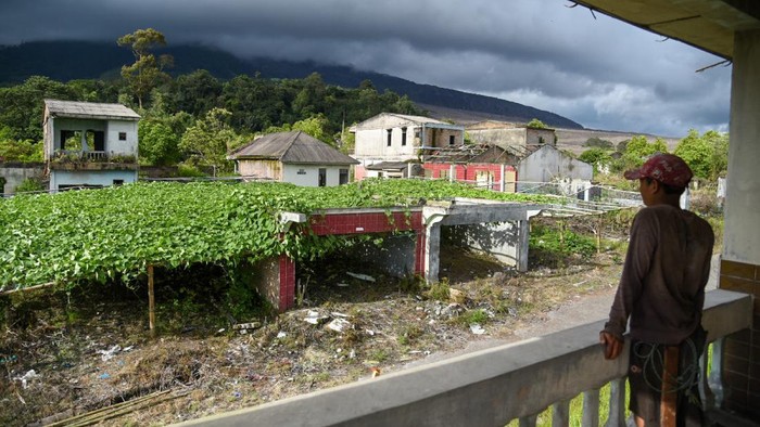 DESA MATI GURUKINAYAN Warga melihat permukiman yang kosong pasca letusan Gunung Sinabung di Desa Gurukinayan, Karo, Sumatera Utara, Senin (29/11/2021). Desa yang terletak di radius tiga kilometer dari kaki Gunung Sinabung tersebut menjadi desa mati setelah ditinggal mengungsi warganya sejak letusan pada tahun 2010 lalu. ANTARA FOTO/Fransisco Carolio/Lmo/rwa.