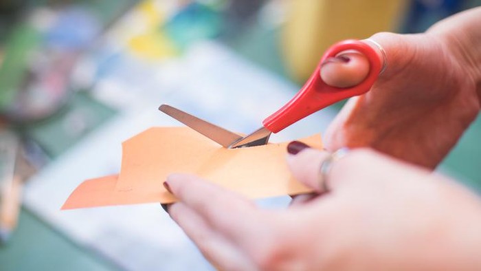 cutting paper with scissors for collage art