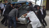 Personel Polisi Pamong Praja dibantu warga memindahkan mobil yang diparkir untuk menghalangi kendaraan petugas saat pembongkaran tempat hiburan ilegal di Jalan Lingkar Selatan, Kramatwatu, Serang, Banten.