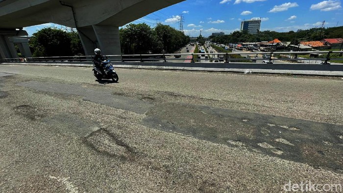 Ampun... Aspal Jalan Keluar Bandara Halim Banyak Lubang Kondisi fisik aspal jalan saat keluar Bandara Halim Perdanakusuma, Jakarta Timur, Kamis (02/12/2021), terlihat banyak berlubang.