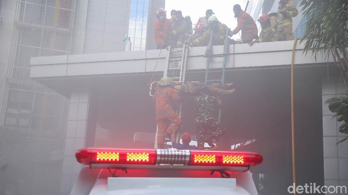 Kebakaran terjadi di Gedung Cyber 1 yang berada di Mampang, Jakarta Selatan. Petugas pemadam kebakaran berjibaku padamkan api dan evakuasi korban, Kamis, (2/12/2021).